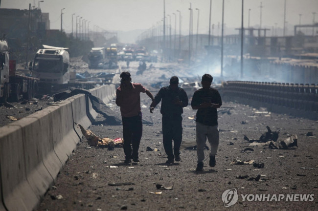 26일(현지시간) 이란 남부 샤히드 라자이항 폭발 현장에서 대피하는 사람들